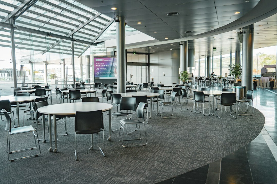 Bright modular conference venue interior with movable furniture and large windows